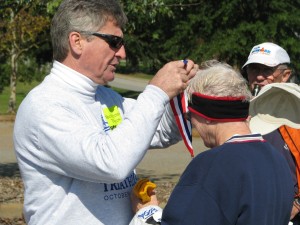 Greg Stewart awards Shirley her medal